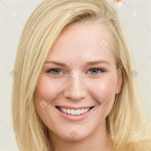 Joyful white young-adult female with long  blond hair and blue eyes