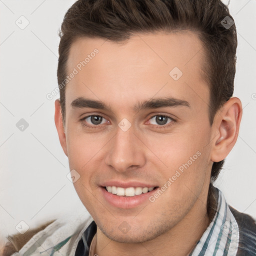 Joyful white young-adult male with short  brown hair and brown eyes