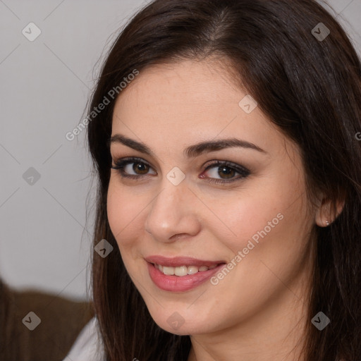 Joyful white young-adult female with long  brown hair and brown eyes