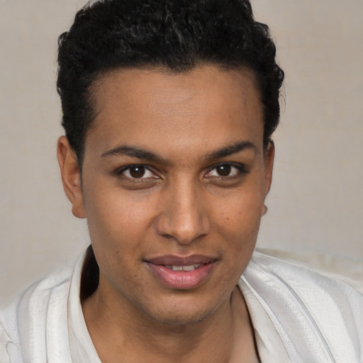 Joyful black young-adult male with short  black hair and brown eyes