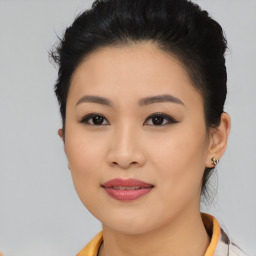 Joyful asian young-adult female with short  black hair and brown eyes