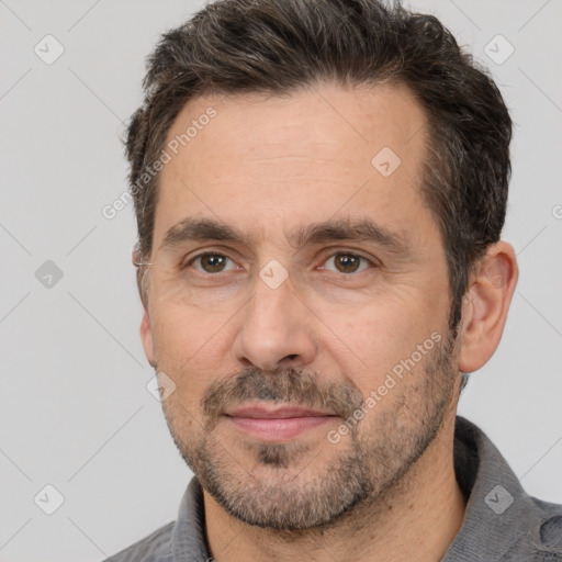 Joyful white adult male with short  brown hair and brown eyes