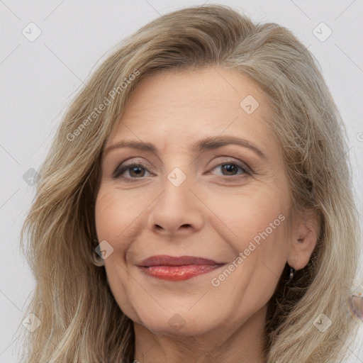 Joyful white adult female with long  brown hair and brown eyes