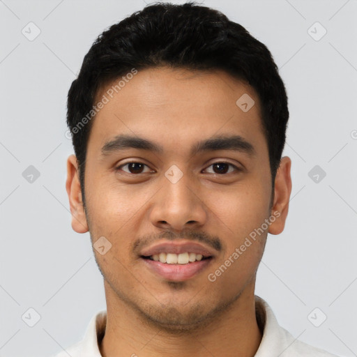 Joyful latino young-adult male with short  black hair and brown eyes