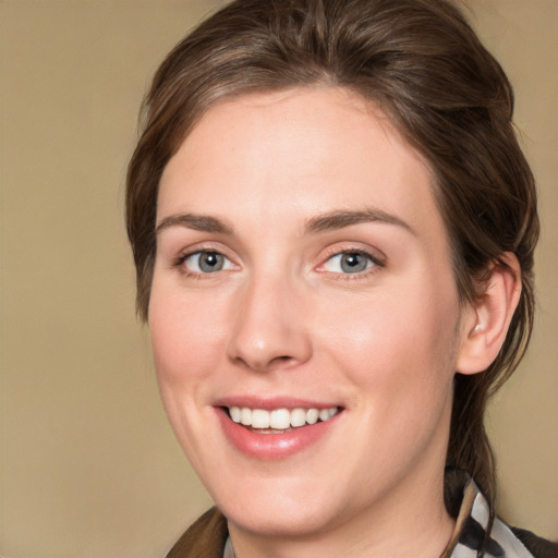 Joyful white young-adult female with medium  brown hair and grey eyes