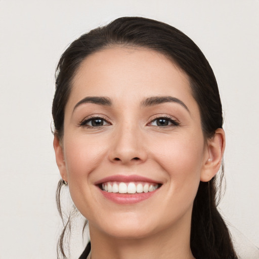 Joyful white young-adult female with long  brown hair and brown eyes