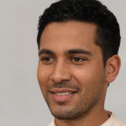 Joyful white young-adult male with short  black hair and brown eyes