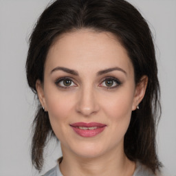 Joyful white young-adult female with medium  brown hair and brown eyes