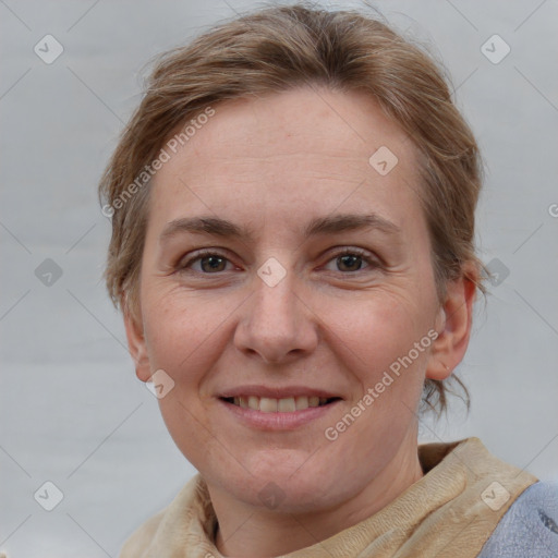 Joyful white adult female with medium  brown hair and blue eyes