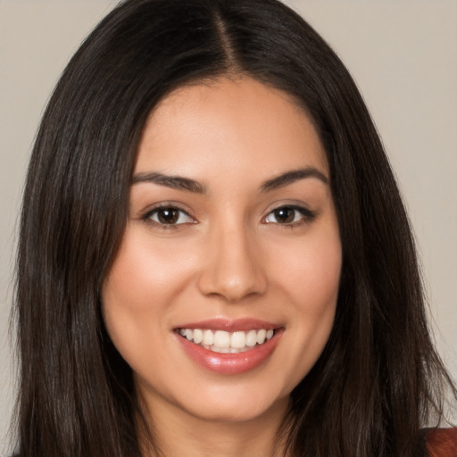 Joyful white young-adult female with long  brown hair and brown eyes