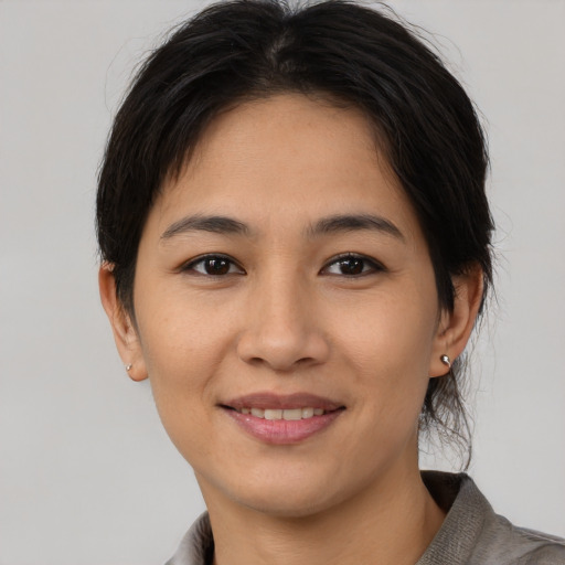 Joyful asian young-adult female with medium  brown hair and brown eyes