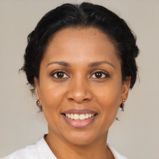 Joyful black adult female with medium  brown hair and brown eyes