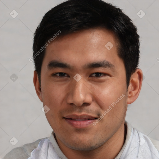 Joyful asian young-adult male with short  black hair and brown eyes