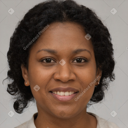 Joyful black adult female with medium  brown hair and brown eyes