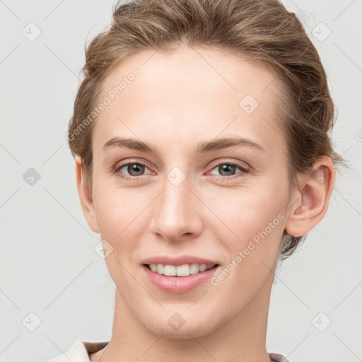 Joyful white young-adult female with short  brown hair and grey eyes