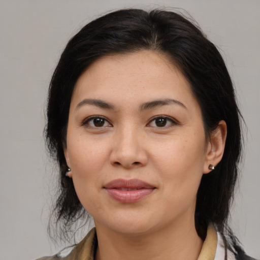 Joyful asian adult female with medium  brown hair and brown eyes