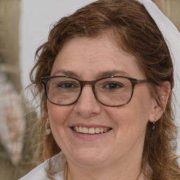 Joyful white adult female with medium  brown hair and brown eyes