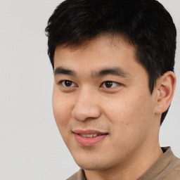 Joyful asian young-adult male with short  black hair and brown eyes