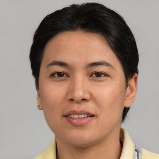 Joyful asian adult female with short  brown hair and brown eyes