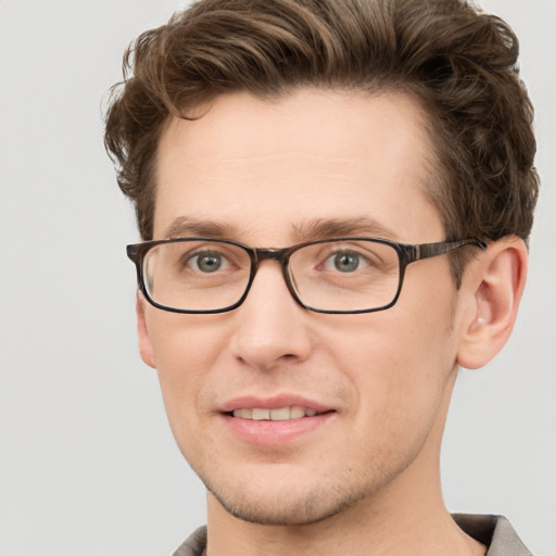 Joyful white adult male with short  brown hair and grey eyes