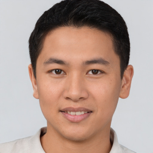 Joyful asian young-adult male with short  brown hair and brown eyes