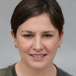 Joyful white young-adult female with short  brown hair and grey eyes