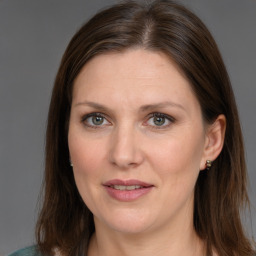 Joyful white adult female with medium  brown hair and grey eyes