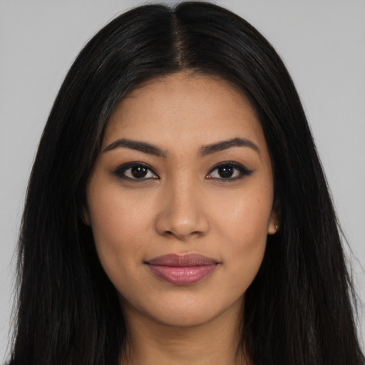 Joyful latino young-adult female with long  black hair and brown eyes
