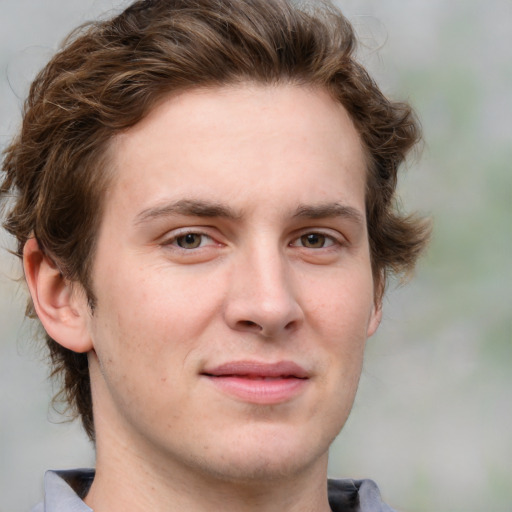 Joyful white young-adult male with medium  brown hair and grey eyes