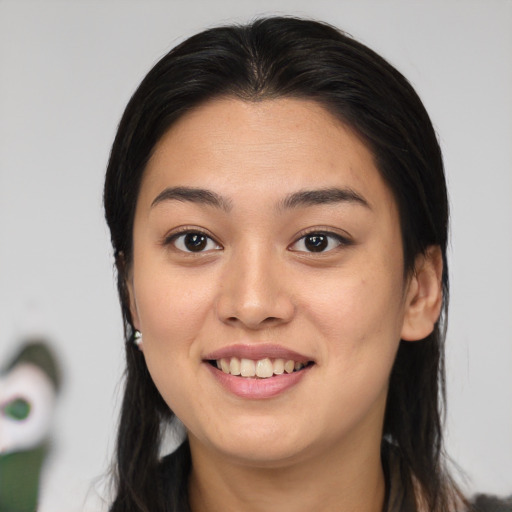 Joyful asian young-adult female with long  brown hair and brown eyes