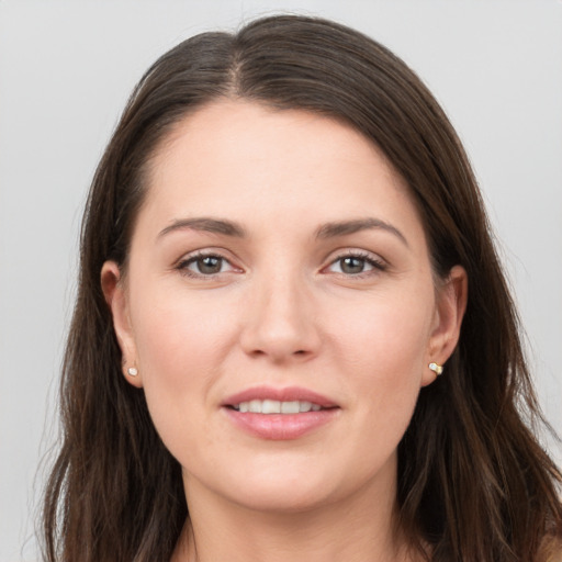 Joyful white young-adult female with long  brown hair and grey eyes