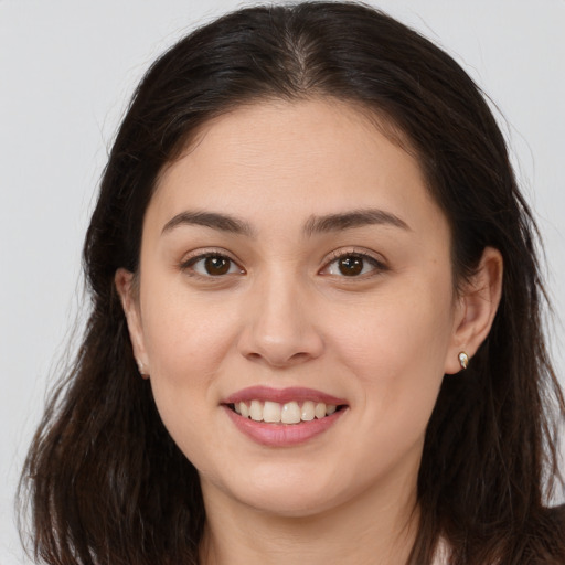 Joyful white young-adult female with long  brown hair and brown eyes