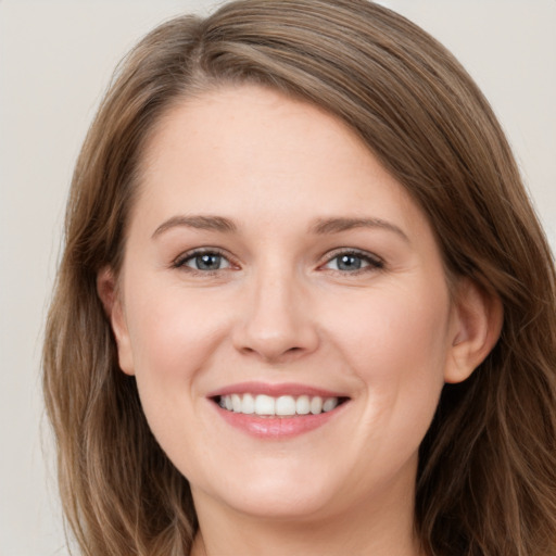 Joyful white young-adult female with long  brown hair and green eyes