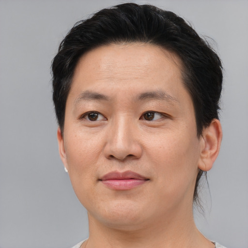 Joyful asian adult female with short  brown hair and brown eyes