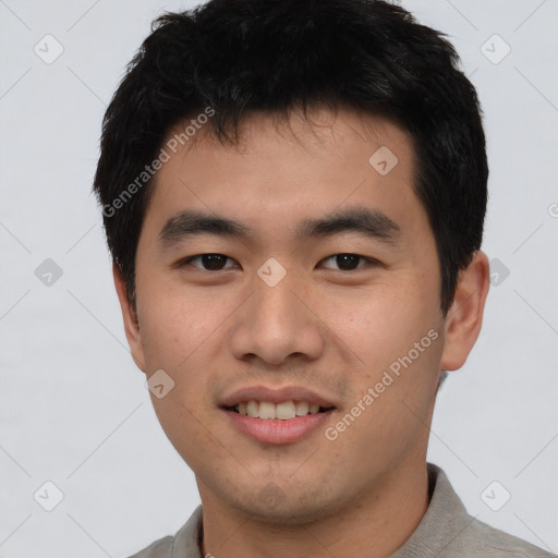 Joyful asian young-adult male with short  black hair and brown eyes