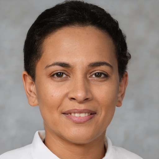 Joyful latino young-adult female with short  brown hair and brown eyes