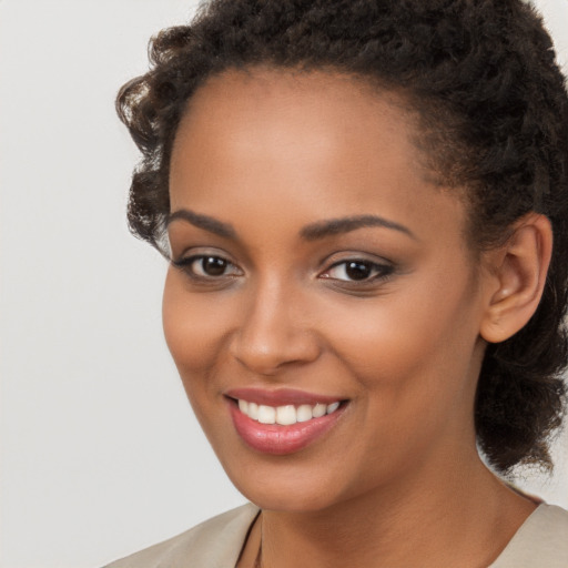 Joyful black young-adult female with short  brown hair and brown eyes