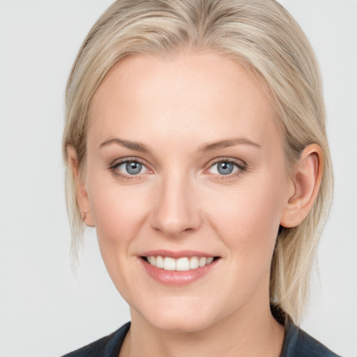 Joyful white young-adult female with medium  blond hair and blue eyes