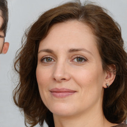 Joyful white adult female with medium  brown hair and brown eyes