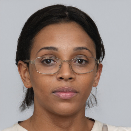 Neutral black adult female with medium  brown hair and brown eyes