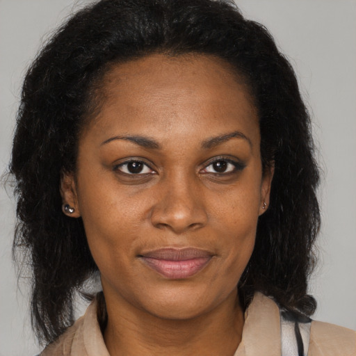 Joyful black adult female with medium  brown hair and brown eyes