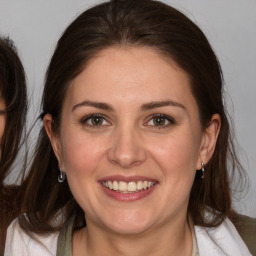 Joyful white adult female with medium  brown hair and brown eyes