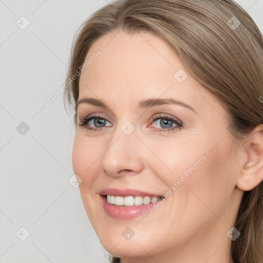 Joyful white young-adult female with long  brown hair and blue eyes