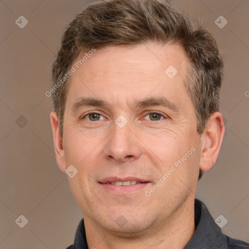 Joyful white adult male with short  brown hair and grey eyes