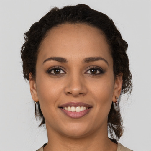 Joyful latino young-adult female with medium  brown hair and brown eyes