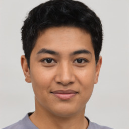 Joyful asian young-adult male with short  black hair and brown eyes