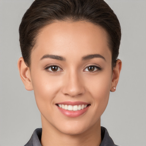 Joyful white young-adult female with short  brown hair and brown eyes