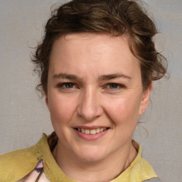 Joyful white young-adult female with medium  brown hair and blue eyes