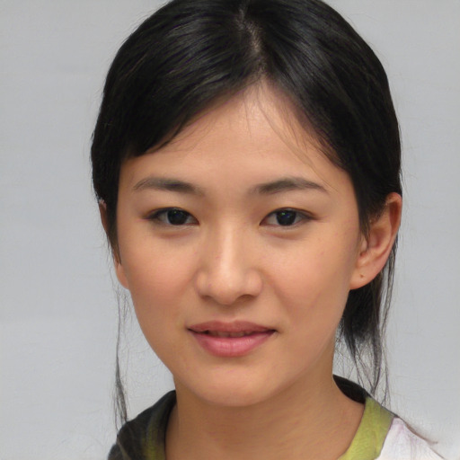 Joyful asian young-adult female with medium  brown hair and brown eyes