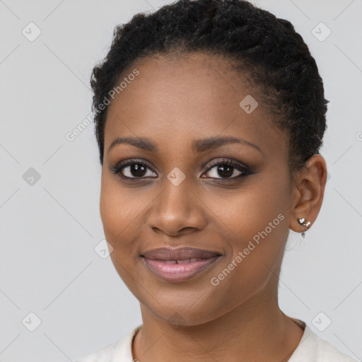 Joyful black young-adult female with short  brown hair and brown eyes